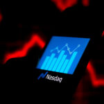 The Nasdaq logo seen displayed with a stock growth bar chart on a smartphone illustrates the risks & consequences of Nasdaq delisting.