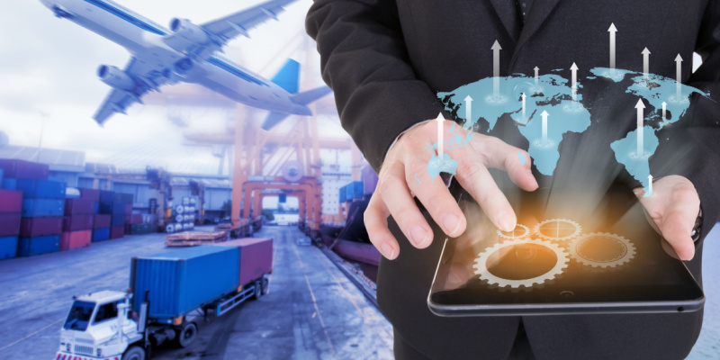 Image of a businessman holding a tablet on a world map with logistic import and export background for Supply Chain Financing With CBDC.