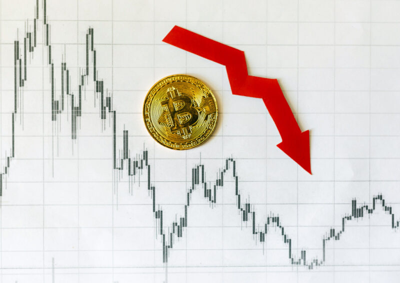 A red downward arrow and golden Bitcoin on the Forex chart index illustrate the impact of the SEC lawsuit on the crypto industry.