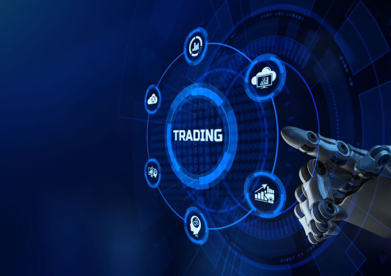 A robotic arm touching a trading button illustrates trade finance automation.