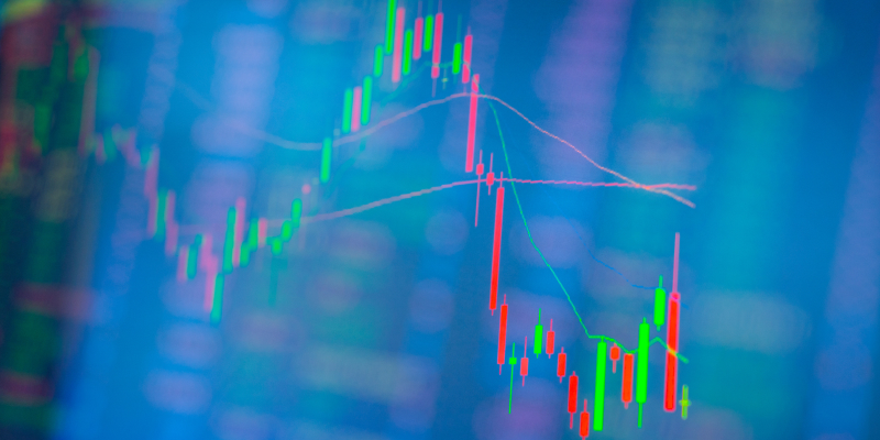 A double exposure image of a technical candlestick stock chart and stock trading illustrates short interest.