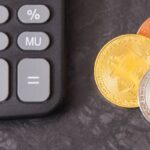 Image of bitcoin coins with calculator as symbol of cryptocurrency in finance.