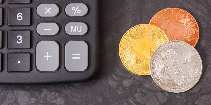 Image of bitcoin coins with calculator as symbol of cryptocurrency in finance.
