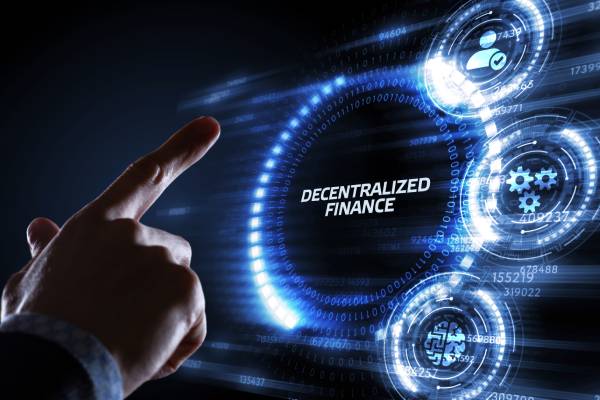 A person pointing at the term decentralized finance on a screen in front of him.